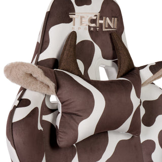 Close up of the cow gaming chair in brown. The brown cow gaming chair has a cow pillow headrest with tectured brown horns and ears that pop out with a fluffy beige lining. The techni sport logo is embroidered in beige. 