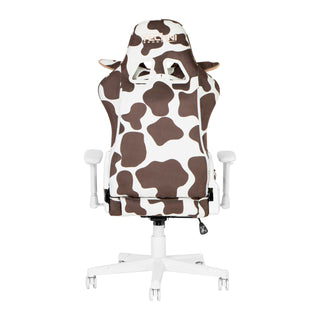 Backview of the cow gaming chair in brown. Brown and white cown print chair with the Techni Sport logo in beige on the top headrest. The cow headrest pillow has ears that peakthrough from the back. 