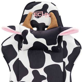 Hands down the best gaming chair for cute setups, here is a close up of the cow headrest pillow with light brown horns and pop out ears lined with fluffy pink material.  The techni sport logo is embroided  in pink on the headrest. The black and white cow print is a soft velvet-like material. 