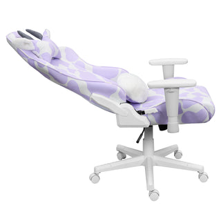 The lavender cow gaming chair is shown in a full 150 degree recline against a white background. This cute gaming chair has white hardware such as 2d armrests, base, wheels and casters. 